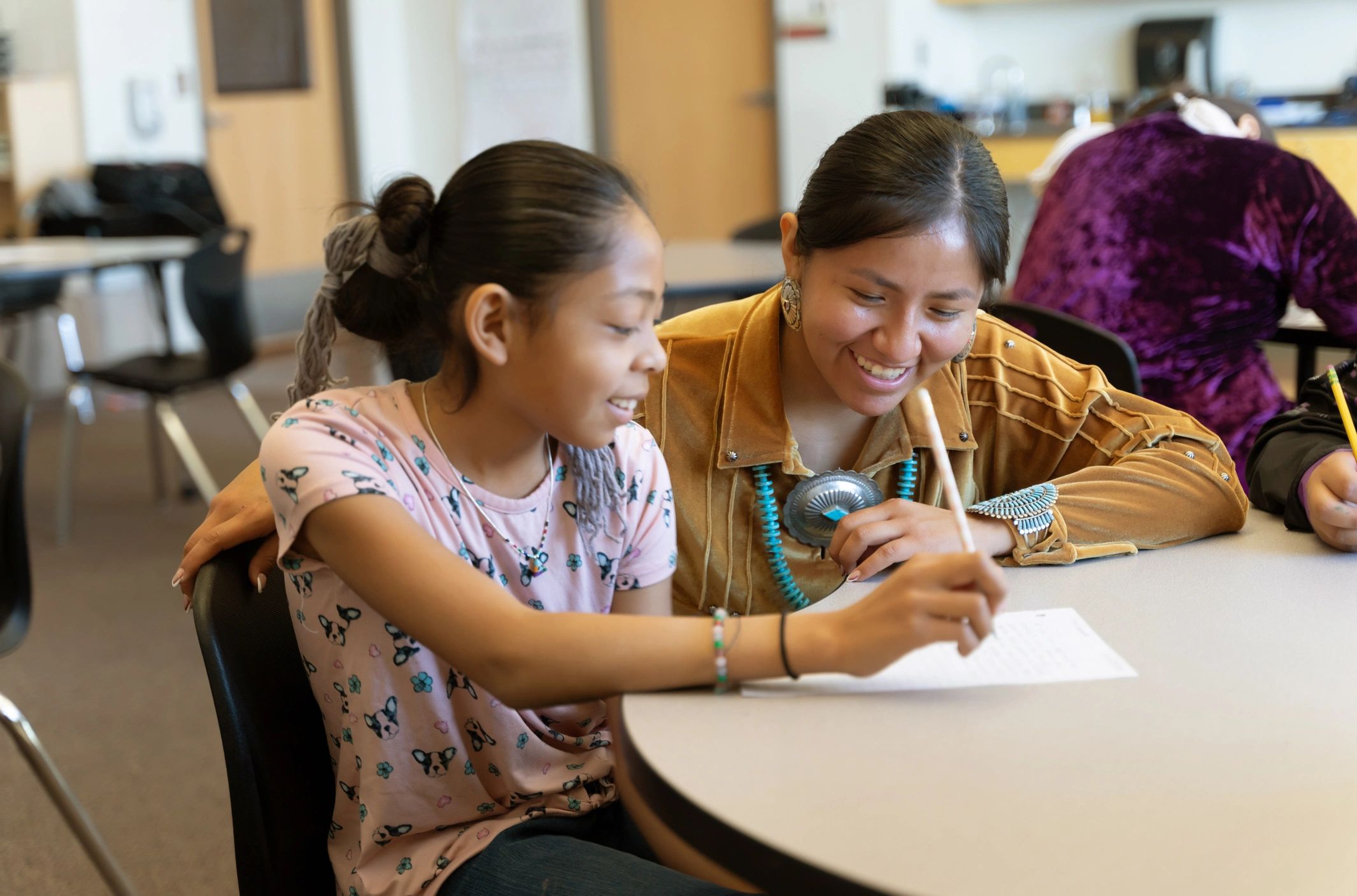 Teacher helping a student one to one