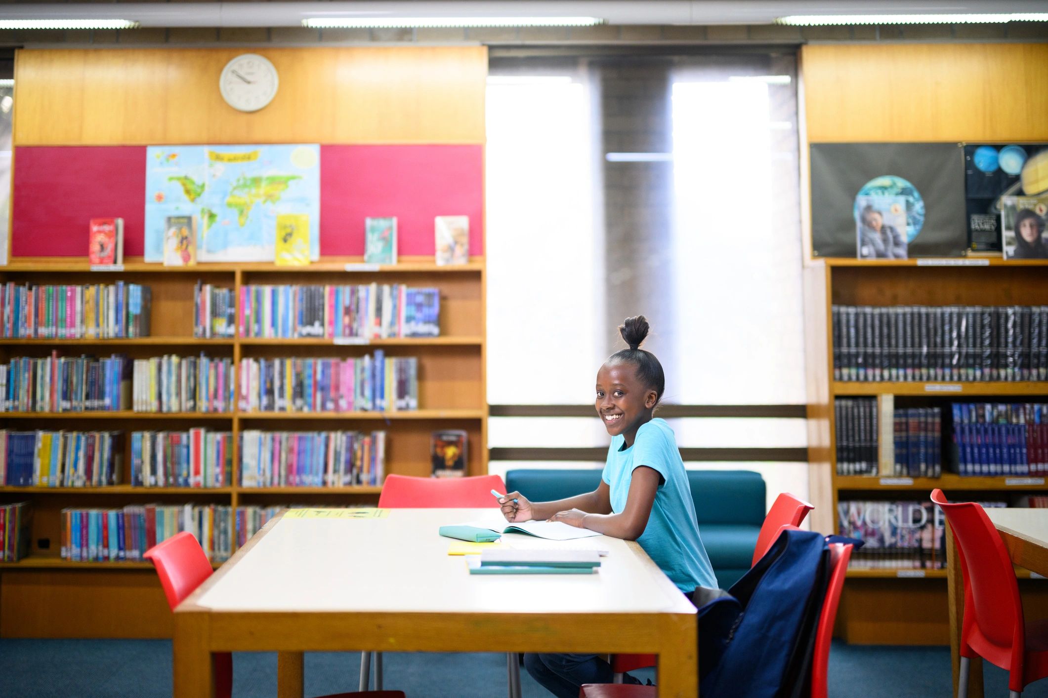 Teen student studying independently in a library