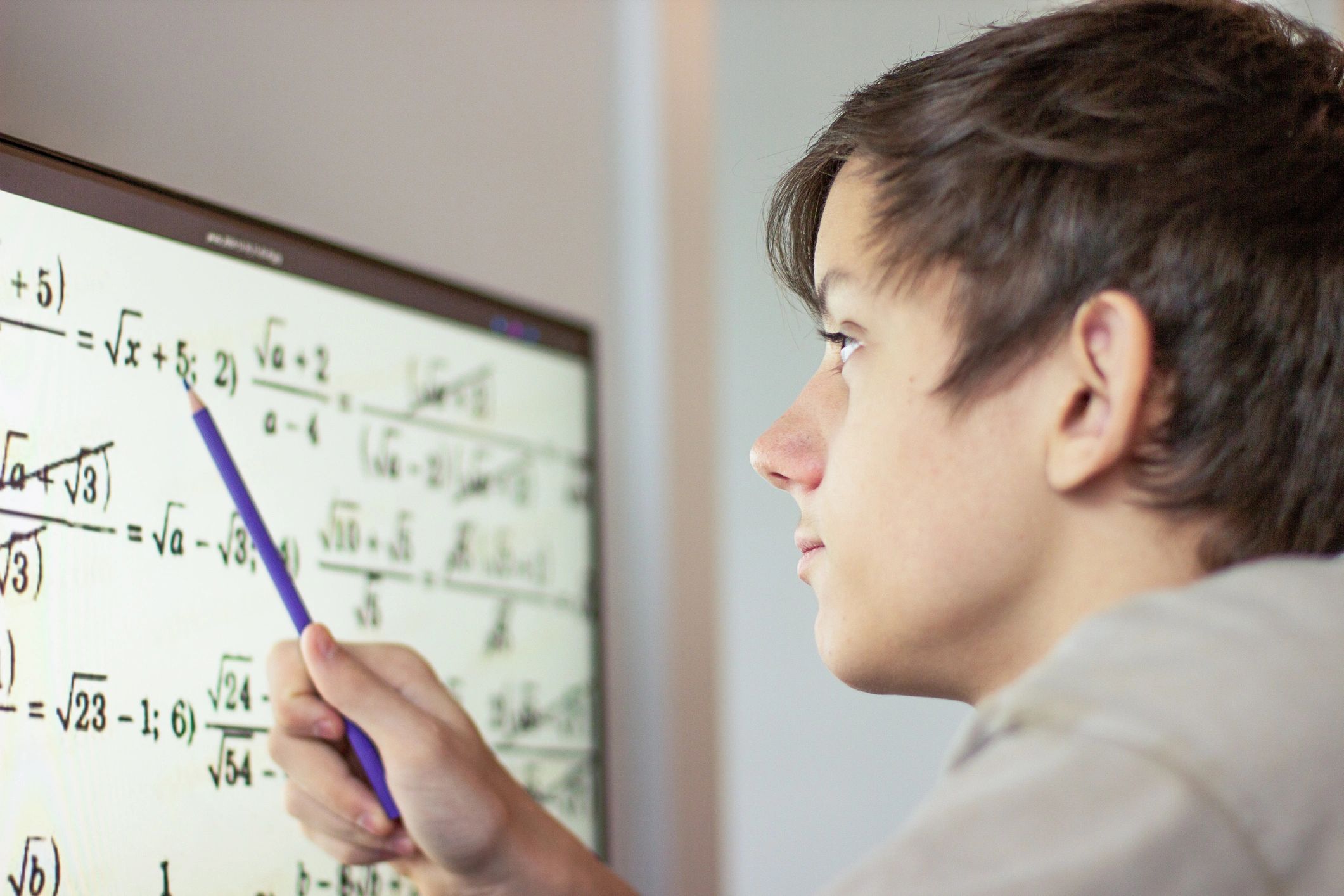 Teenage student studying mathematics online