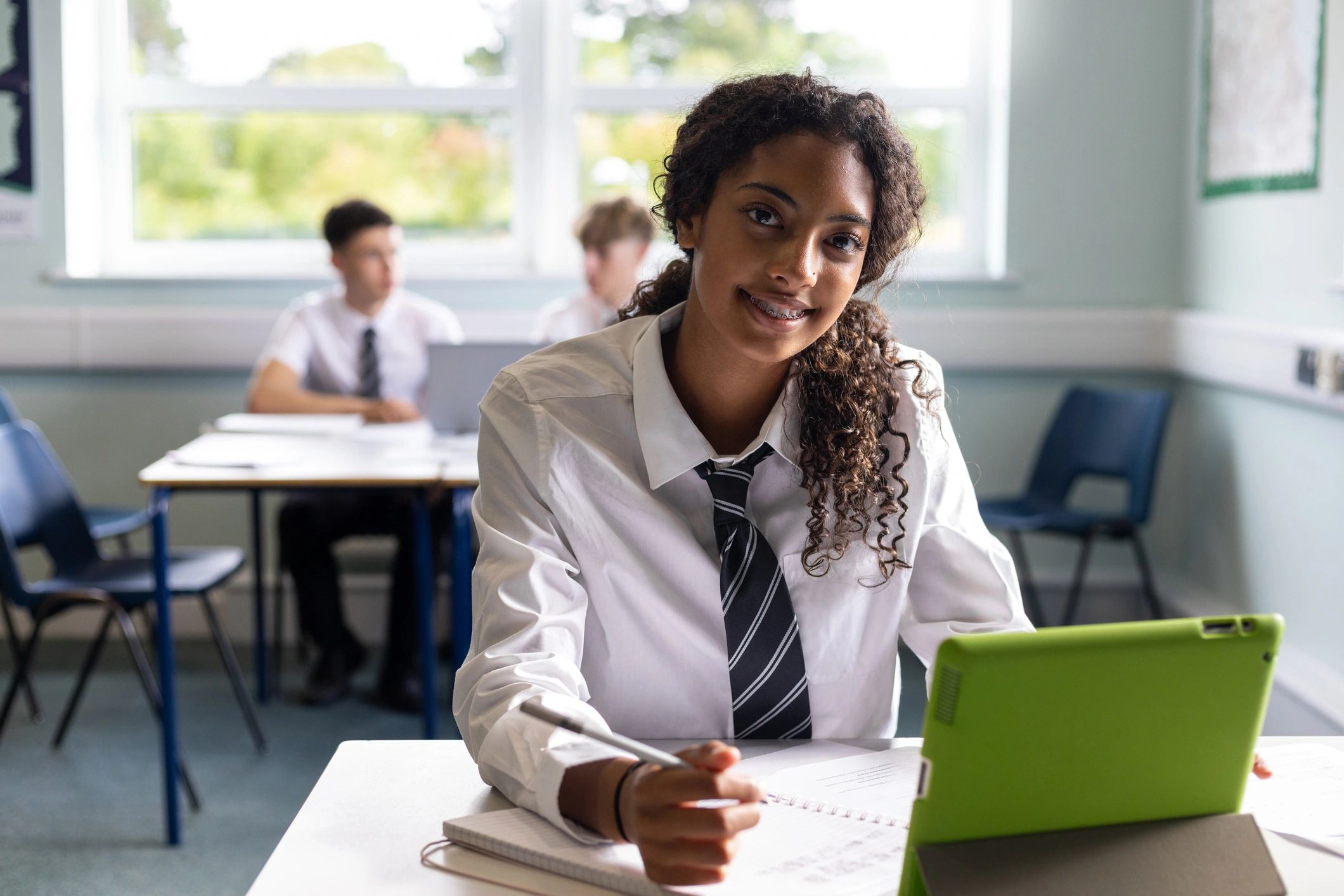 Teenage student smiling at school