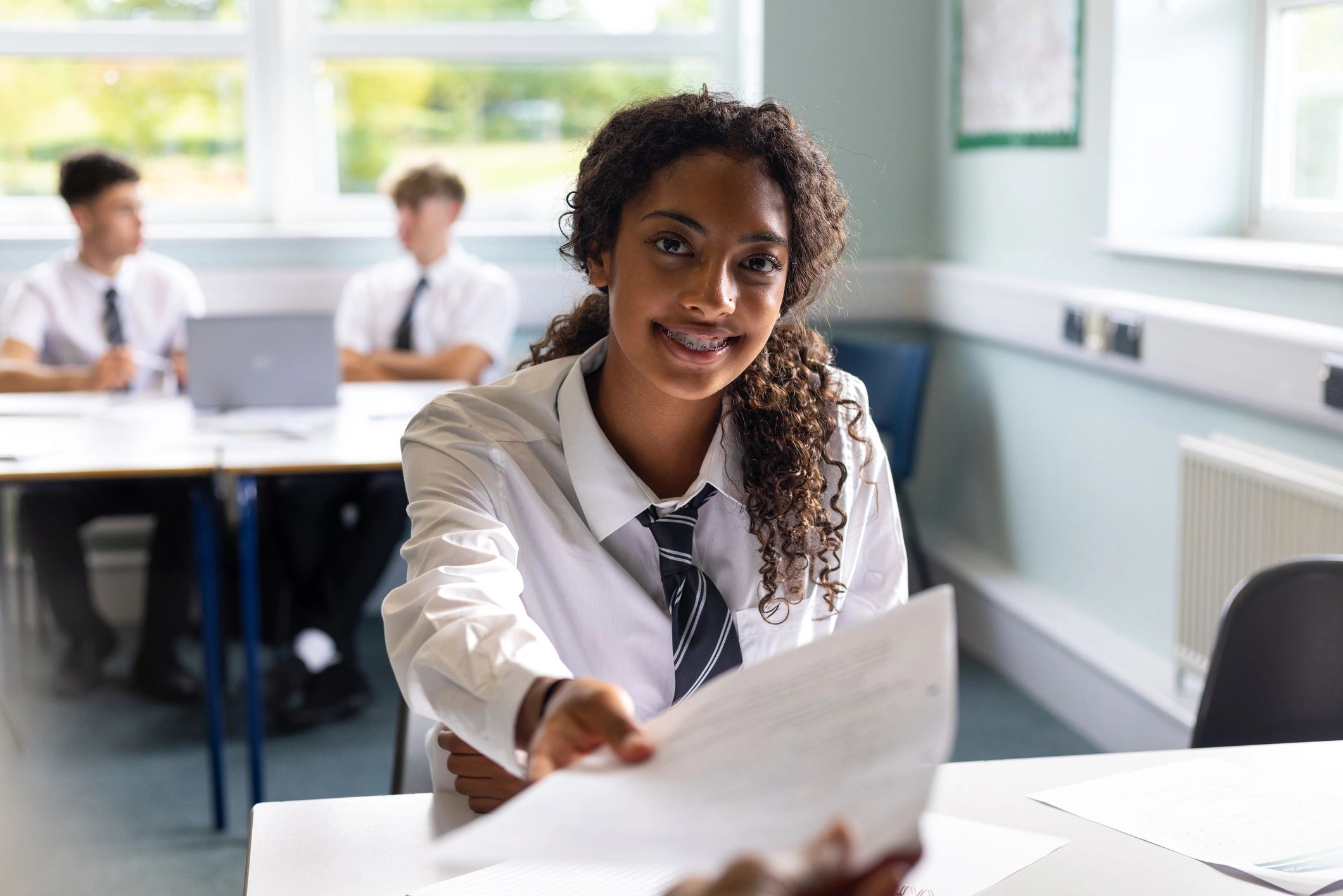 High school student smiling in a classroom